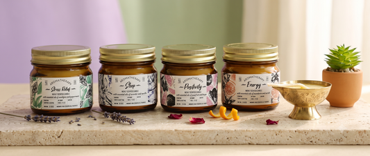 Four different scented aromatherapy candles labeled with mood-based names arranged for comparison