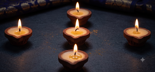 Rows of clay cow ghee diyas arranged for community lighting at a temple