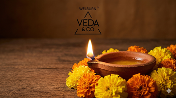 Pure cow ghee clay diya showing a steady golden flame — Veda & Co