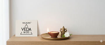 A single lit diya for pooja on a clean, simple home altar representing daily practice — Veda & Co