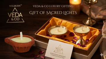 A pure cow ghee diya with a steady golden flame on a traditional brass puja thali — Veda & Co