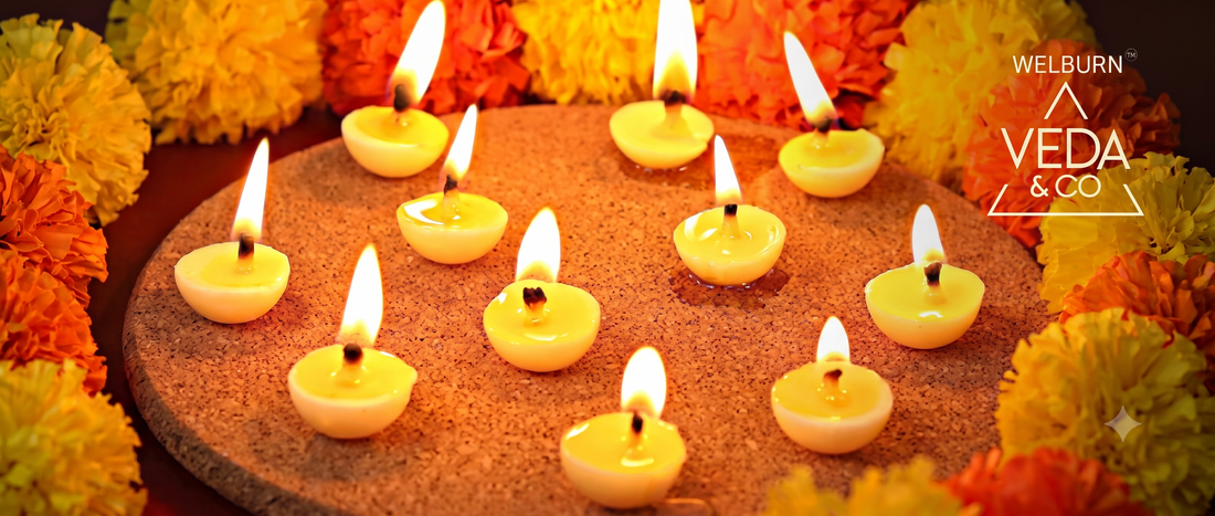 Rolled cotton ghee batti wicks beside a lit clay diya with a steady flame