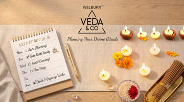 Ghee batti wicks and a lit diya arranged beside a calendar to represent monthly planning