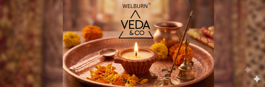 Close-up of a lit pure cow ghee clay diya on a puja thali with marigold flowers