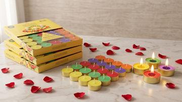 Several packs of scented tealight candles with different burn-time labels displayed together