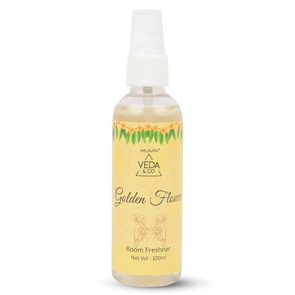 Golden flower fragrance room freshener spray close-up view